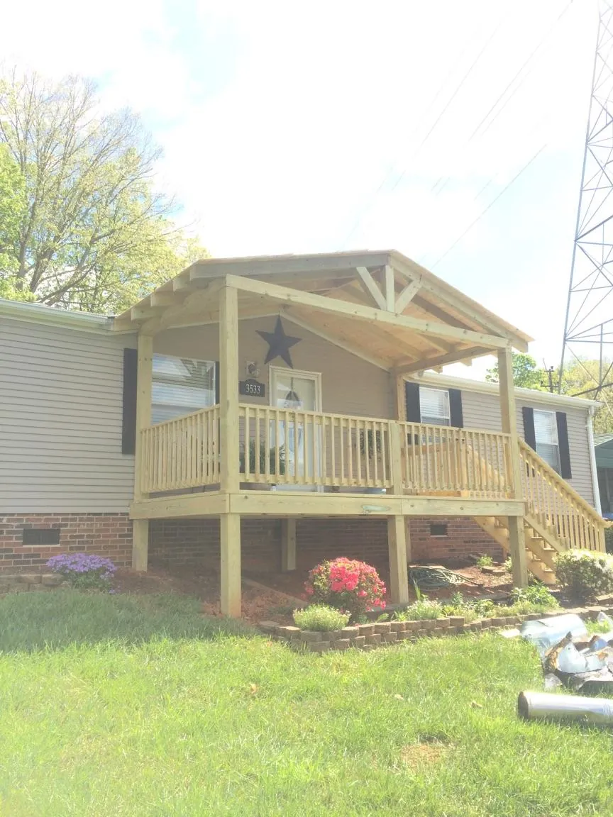 New gabled porch roof and deck railing added to a ranch home in Lake Dallas